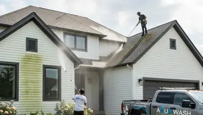 Technician cleaning residential roof with safe wash system in Raleigh, NC for Next Level Exteriors